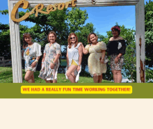 a group of women are posing for a picture under a c resort sign