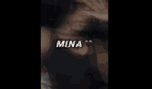 a blurred image of a woman with mina written on the top