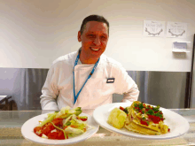 a man in a chef 's uniform stands in front of two plates of food and a sign that says kitchen staff only