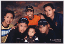 a group of young men posing for a photo with celebrity photo studio in the corner