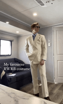 a man in a white suit is standing in a room with the words " my favourite rwrb costume " on the bottom