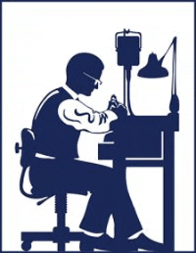 a silhouette of a man sitting at a desk working on a piece of equipment .