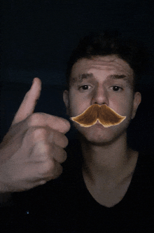 a young man with a fake mustache on his face giving a thumbs up