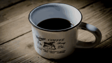 a vintage coffee mug that is on a wooden table