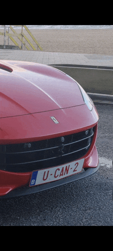 a red sports car with the license plate u-can-2