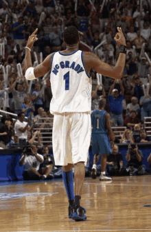 a basketball player wearing a number 1 jersey stands on the court