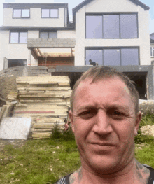 a man is standing in front of a house that is being built