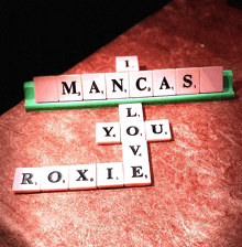 a scrabble board with the words i mancas l you v roxie on it