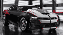 a black and white chevrolet camaro with eagle goodyear tires