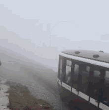 a train is going down a track in the fog