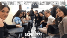 a group of girls are sitting at desks in a classroom with the caption wait did you say your a streamer