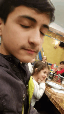 a young boy and a little girl are sitting at a table