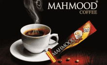 a cup of mahmood coffee next to a package of coffee