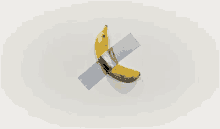 a banana is taped to a white wall