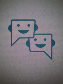 two speech bubbles with smiling faces on them on a computer screen