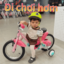 a little girl riding a pink btwin bicycle