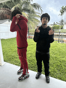 a man in a red hoodie is standing next to another man