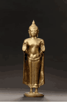 a statue of a buddha with a crown on top of his head