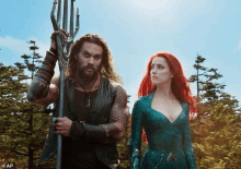 a man with a trident and a woman with red hair