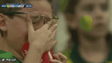 a boy drinks from a coca cola can while watching a soccer game on espn