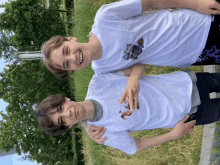 two boys are posing for a picture with one wearing a t-shirt that says ' a ' on it