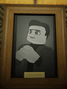 a framed portrait of cave johnson with a name plate