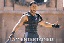 a man in a gladiator costume is holding a sword and says " i am entertained "