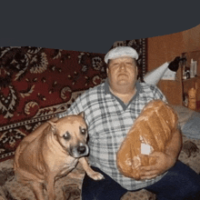 a man is holding a loaf of bread next to a small dog