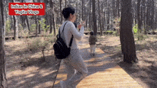 a woman taking a picture of a child in a forest with the words indian in china and yogita vlogs