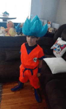 a young boy in a dragon ball z costume stands in a living room