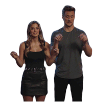 a man and a woman are standing next to each other holding hands