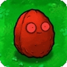 a red walnut with red eyes is sitting on a green field .