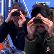 two men are looking through binoculars on a screen that says de viernes manana