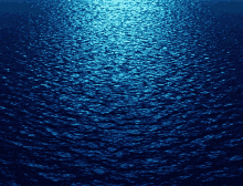 a dark blue water surface with a few waves