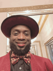 a man wearing a red hat and a bow tie