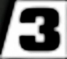 a close up of a black and white number 3