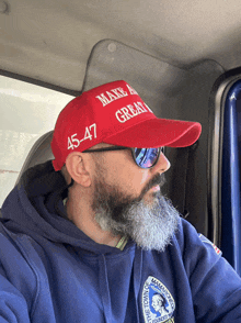 a man wearing a make america great hat