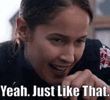 a woman in a fireman 's uniform is smiling and says yeah just like that