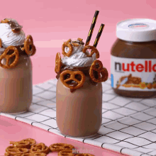 a jar of nutella sits next to a milkshake