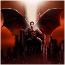 a man with wings is sitting on a throne in a dark room