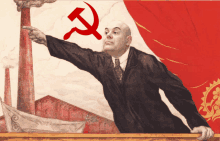 a man pointing at a hammer and sickle on a red background