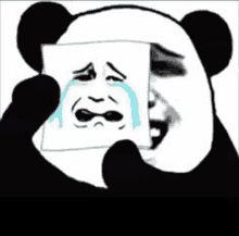 a panda is holding a picture of a crying face .