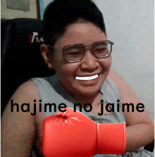 a man wearing glasses and a red boxing glove with the word hajime on it