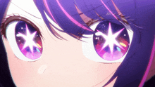 a close up of a girl 's eyes with a star reflection