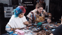 a man and a woman playing a board game with a sign that says black lives matter in the background