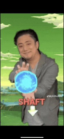 a man in a suit is holding a blue ball and the word shaft is on the bottom