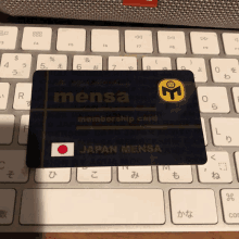 a mensa membership card sits on a keyboard