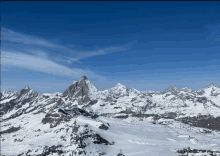 a snowy mountain range with a blue sky