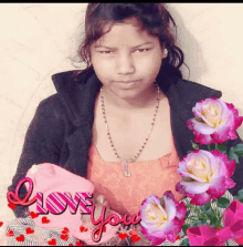 a girl is surrounded by pink flowers and a sign that says i love you