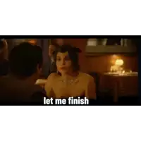 a woman in a cat costume is talking to a man in a restaurant and says `` let me finish '' .